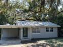 One story house with carport and green door at 104 E Mcclendon St, Lady Lake, FL 32159