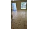 Living room with light beige tile flooring at 7622 Forest City Rd # E, Orlando, FL 32810
