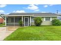Ranch home with a covered porch and lush green lawn at 106 Oregon Ave, Saint Cloud, FL 34769