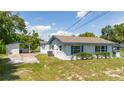 View of back of house, detached shed, and yard at 168 E Sunset St, Groveland, FL 34736