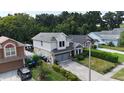 Two-story house with gray garage doors and landscaping at 5410 Old Oak Tree Dr, Orlando, FL 32808