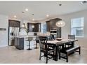 Spacious kitchen with island, stainless steel appliances, and dark cabinetry at 7635 Taormina Way, Clermont, FL 34714