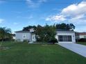 Single-story home with green lawn and palm tree at 1411 Swift Ct, Kissimmee, FL 34759