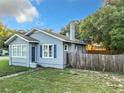 Side view of a blue house with a wooden fence at 1628 S Grove St, Eustis, FL 32726