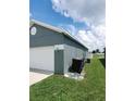 Gray house with white garage door, and green lawn at 714 Hacienda Cir, Kissimmee, FL 34741