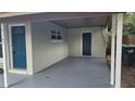 Covered carport with a freshly coated floor and storage area at 5107 Indialantic Dr, Orlando, FL 32808