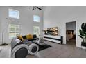 Spacious living room with L-shaped sofa and large TV at 145 Cork Way, Davenport, FL 33897