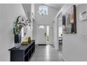 Elegant entryway with tile floors and modern decor at 145 Cork Way, Davenport, FL 33897
