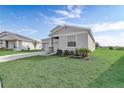 One-story home with gray siding, stone accents, and a two-car garage at 687 Hitch Loop, Saint Cloud, FL 34772