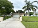 House exterior showcasing a two-car garage and landscaped front yard at 307 Colonade Ct, Kissimmee, FL 34758