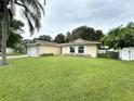 Landscaped yard with a single-story home featuring a large front lawn at 307 Colonade Ct, Kissimmee, FL 34758