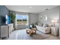 Living room with sectional sofa and large window at 508 Taylor Groves Dr, Lake Wales, FL 33853