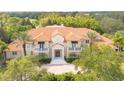 Luxury home with a terracotta tile roof and lush landscaping at 5174 Vardon Dr, Windermere, FL 34786