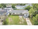 Aerial view of a house with a spacious yard and driveway at 8116 Powell Dr, Orlando, FL 32822