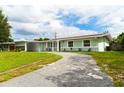 Newly renovated home with a long driveway and attractive landscaping at 5709 Ridgeway Dr, Orlando, FL 32819