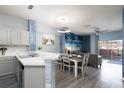 Open concept kitchen and dining area with beach-themed decor at 3052 Secret Lake Dr, Kissimmee, FL 34747
