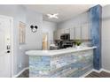 Stylish kitchen with a unique backsplash and breakfast bar at 3052 Secret Lake Dr, Kissimmee, FL 34747