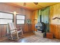 Cozy living room with wood-burning stove and rocking chair at 6799 Chad Jason Rd, Saint Cloud, FL 34773