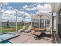 Screened patio with pool, spa, lounge chairs, and dining area at 9102 Sommerset Hills Dr, Davenport, FL 33896