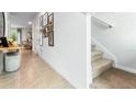 Modern staircase with carpeted steps and tiled hallway at 2376 Penguin Blvd, Davenport, FL 33837