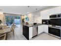 Modern kitchen with stainless steel appliances and a breakfast bar at 17204 Blessing Dr, Clermont, FL 34714