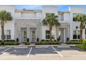 Modern three-unit building with stone accents and palm trees at 17204 Blessing Dr, Clermont, FL 34714