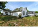 Back of house with pool, shed, and fenced backyard at 2717 Bayview Dr, Eustis, FL 32726