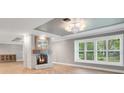 Bright living room with fireplace and herringbone floors at 235 Oakdale St, Windermere, FL 34786