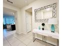 Bright and airy entryway with a white console table and large mirror at 710 Gardenia Ln, Davenport, FL 33897