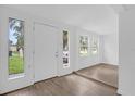 Bright entryway with wood-look flooring and multiple windows at 839 Kensington Dr, Orlando, FL 32808