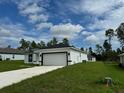 Single-story home with white exterior, black accents, and a two-car garage at 2491 Sw 170Th Loop, Ocala, FL 34473