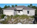 New construction home with block exterior and two-car garage at 619 Alafia Pl, Poinciana, FL 34759