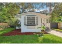 White bungalow with a bay window and a well-maintained lawn at 1815 Larkin Ave, Orlando, FL 32812