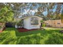 Charming white bungalow home with a lush green lawn at 1815 Larkin Ave, Orlando, FL 32812