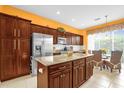 Spacious kitchen with island and orange walls at 500 Arena Dr, Davenport, FL 33837