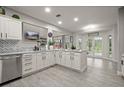 Spacious kitchen featuring white cabinets, granite countertops, and stainless steel appliances at 2393 Appy Ln, Apopka, FL 32712