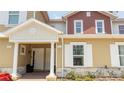 Townhouse exterior with two-toned siding and columns at 7514 Sunflower Cir, Kissimmee, FL 34747
