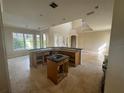 Spacious kitchen featuring an island and breakfast bar, open to the Gathering room at 7706 Excitement Dr, Reunion, FL 34747
