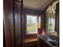 Wet bar with granite countertop, wine rack, and wrought iron accents at 7706 Excitement Dr, Reunion, FL 34747