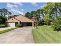 Front view of a two-unit house with driveway at 116 Avocet Ct, Daytona Beach, FL 32119