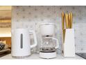 Close-up of modern coffee maker and kettle at 6165 Carrier Dr # 1210, Orlando, FL 32819