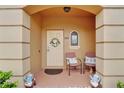 Townhouse entry with two chairs and garden gnomes at 3326 Calabria Ave, Davenport, FL 33897