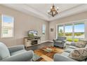 Spacious living room with comfy seating and a view of the lake at 8632 Bridgeport Bay Cir, Mount Dora, FL 32757