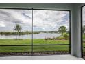 Relaxing screened porch overlooking a tranquil lake at 8632 Bridgeport Bay Cir, Mount Dora, FL 32757