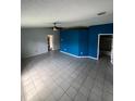 Spacious living room with tile floors and blue accent wall at 733 Robin Ct, Kissimmee, FL 34759