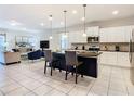 Modern kitchen with white cabinets and large island at 8844 Corcovado Dr, Kissimmee, FL 34747