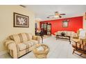 Living room with tiled floors, neutral colored furniture, and an accent wall at 894 Quarters Ct, Port Orange, FL 32129