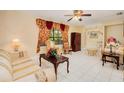 Living room with tiled floor, featuring a comfortable seating area and large window at 894 Quarters Ct, Port Orange, FL 32129