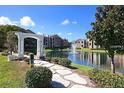 Community features a serene lake with walking paths and beautiful landscaping at 4400 Thornbriar Ln # A202, Orlando, FL 32822