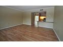 Living room with laminate flooring and kitchen view at 103 Oyster Bay Cir # 120, Altamonte Springs, FL 32701